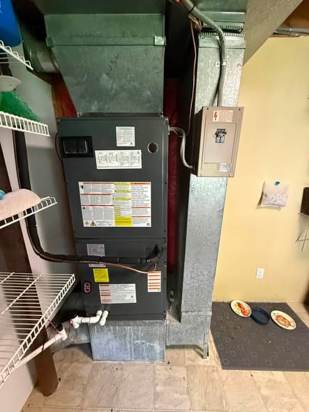 Furnace and supply plenum in a basement utility room